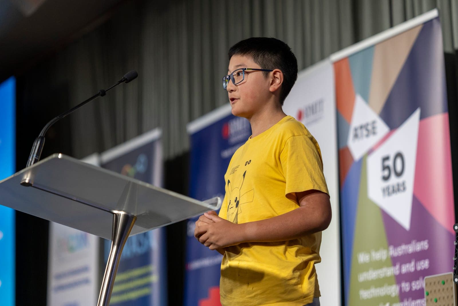 A 2025 finalist speaking at the Grand Final podium