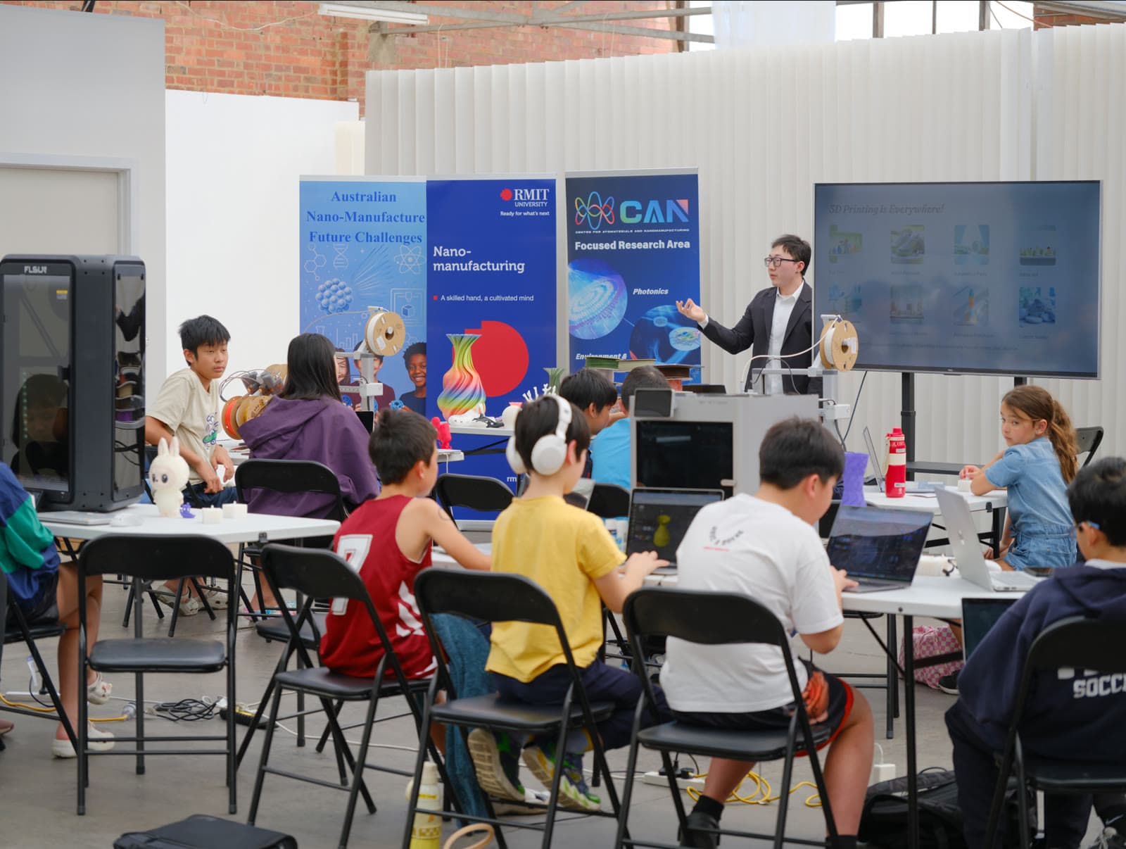 Students at laptops during a 2025 ANMFC library workshop
