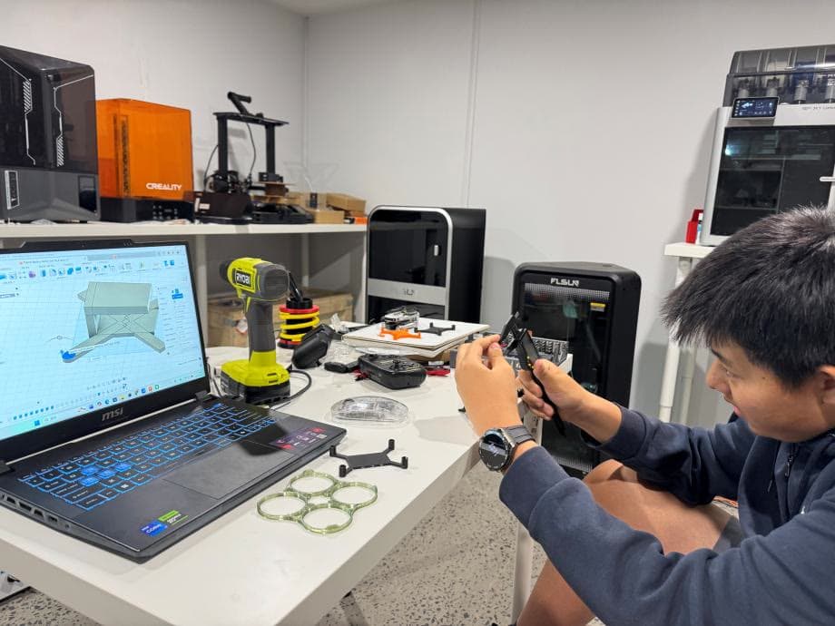 A student measuring a printed part in the Scan&Print3D workshop